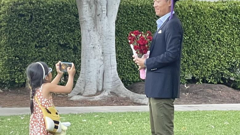 Proud moment little girl snapped photos of her father at his graduation